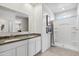 Bathroom showcases double vanity, granite countertop, walk-in shower with gray tones and neutral walls at 1404 W Kennedy Ave, Coolidge, AZ 85128