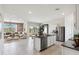 Open-concept living space featuring kitchen island, living room, and seamless access to the outdoors at 1404 W Kennedy Ave, Coolidge, AZ 85128