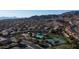 An aerial view of the community showcasing a pool, tennis courts, and lush landscaping against a mountain backdrop at 14052 S 24Th Way, Phoenix, AZ 85048