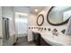 Bathroom featuring double sinks, dark wood cabinets, and a shower/tub combo at 14052 S 24Th Way, Phoenix, AZ 85048