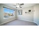 Well-lit bedroom with a large picture window showcasing views of the neighborhood at 14052 S 24Th Way, Phoenix, AZ 85048