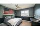 Cozy bedroom with neutral color palette, ceiling fan and a large American flag at 14052 S 24Th Way, Phoenix, AZ 85048