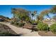 A park bench rests on a paved path surrounded by desert landscaping and palm trees in a well-maintained community park at 14052 S 24Th Way, Phoenix, AZ 85048