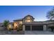 Beautiful two-story house showcasing its well-manicured front yard and elegant architectural details at twilight at 14052 S 24Th Way, Phoenix, AZ 85048