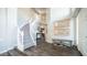 Elegant foyer showcasing a curved staircase, wood floors, and decorative wall art, creating a welcoming ambiance at 14052 S 24Th Way, Phoenix, AZ 85048