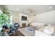 Comfortable living room featuring a fireplace, ceiling fan, and large windows at 14052 S 24Th Way, Phoenix, AZ 85048