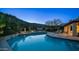 Tranquil swimming pool with stone surround and lush landscaping against a mountain backdrop at 14052 S 24Th Way, Phoenix, AZ 85048