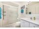 Well-lit bathroom featuring a shower with glass doors, white vanity, toilet and coordinating accessories at 14209 N Palm Ridge Dr, Sun City, AZ 85351