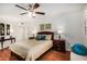 Bedroom featuring a ceiling fan, nightstands, and hardwood floors at 14209 N Palm Ridge Dr, Sun City, AZ 85351