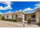 Single-story home with manicured shrubs and a well-maintained front yard at 14209 N Palm Ridge Dr, Sun City, AZ 85351