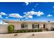 Single-story home with manicured shrubs in a well-maintained desert front yard at 14209 N Palm Ridge Dr, Sun City, AZ 85351