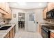 Well-lit kitchen featuring granite countertops, sleek black appliances, and tiled backsplash at 14209 N Palm Ridge Dr, Sun City, AZ 85351