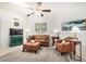 Cozy living room featuring plush seating, a ceiling fan, and tasteful decor at 14209 N Palm Ridge Dr, Sun City, AZ 85351