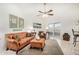 Comfortable living room with a ceiling fan, tile floors, and sliding glass doors at 14209 N Palm Ridge Dr, Sun City, AZ 85351