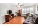 Bright living room with hardwood floors, fan, plantation shutters, and comfortable seating at 14209 N Palm Ridge Dr, Sun City, AZ 85351