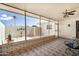 Enclosed patio featuring tiled floors, sun protection, and serene outdoor views at 14209 N Palm Ridge Dr, Sun City, AZ 85351