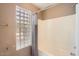 Bathroom featuring a shower and block-glass window for privacy and natural light at 14410 N Silverado Dr, Fountain Hills, AZ 85268