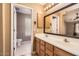 Bathroom featuring dual sinks, tile flooring, and an open doorway to the toilet and shower at 14410 N Silverado Dr, Fountain Hills, AZ 85268