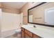 A bathroom with a single sink vanity, a framed mirror, and a shower-tub combination at 14410 N Silverado Dr, Fountain Hills, AZ 85268