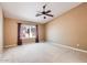 Primary bedroom with neutral carpeting and a large window providing natural light at 14410 N Silverado Dr, Fountain Hills, AZ 85268