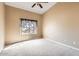 Neutral bedroom featuring a ceiling fan and a large window offering natural light at 14410 N Silverado Dr, Fountain Hills, AZ 85268