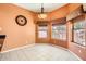 Breakfast nook featuring three large windows for optimal natural light, plus a charming hanging light fixture at 14410 N Silverado Dr, Fountain Hills, AZ 85268