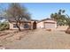 Single-story home featuring low-maintenance landscaping, two-car garage, and tile roof at 14410 N Silverado Dr, Fountain Hills, AZ 85268