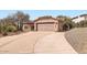 Charming single-story home featuring a spacious driveway, two-car garage, and Southwestern-style architecture at 14410 N Silverado Dr, Fountain Hills, AZ 85268