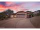 Charming single-story home featuring a spacious driveway, two-car garage, and Southwestern-style architecture at 14410 N Silverado Dr, Fountain Hills, AZ 85268