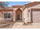 Entryway with an arched portico, natural stone siding, and low-maintenance xeriscape landscaping at 14410 N Silverado Dr, Fountain Hills, AZ 85268