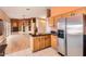 Open-concept kitchen with tile floors and stainless steel appliances adjacent to a living area with a fireplace at 14410 N Silverado Dr, Fountain Hills, AZ 85268