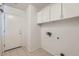 Bright laundry room with white cabinets and tiled floors at 14410 N Silverado Dr, Fountain Hills, AZ 85268