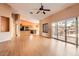 Open-concept living room with wood floors leads to the kitchen and has direct access to the back patio at 14410 N Silverado Dr, Fountain Hills, AZ 85268