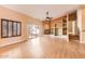 Bright and airy living room with fireplace, built-in shelving, wood floors, and access to the back patio at 14410 N Silverado Dr, Fountain Hills, AZ 85268