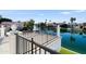 Backyard canal view from wrought iron fence, showing neighboring houses and clear blue sky at 1523 E Treasure Cove Dr, Gilbert, AZ 85234