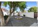 Charming courtyard featuring a decorative fountain, stone pavers, and mature trees, creating a serene outdoor space at 1523 E Treasure Cove Dr, Gilbert, AZ 85234