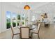 Dining area with lake views, and a view into the open kitchen, enhancing the home's layout at 1523 E Treasure Cove Dr, Gilbert, AZ 85234