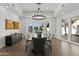 Elegant dining room with chandelier and windows with pool view at 1523 E Treasure Cove Dr, Gilbert, AZ 85234