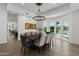 Bright dining room with modern chandelier and views of backyard pool at 1523 E Treasure Cove Dr, Gilbert, AZ 85234