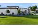 Lush green lawn and professional landscaping highlight the architectural details of this stunning estate at 1523 E Treasure Cove Dr, Gilbert, AZ 85234