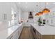 Open kitchen with a large island, white countertops, a copper range hood, and modern lighting at 1523 E Treasure Cove Dr, Gilbert, AZ 85234