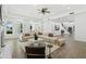 Expansive living room featuring a large white sectional sofa, fireplace, and built-in bookshelves at 1523 E Treasure Cove Dr, Gilbert, AZ 85234