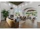 Elegant living room with fireplace, large windows, wood floors, and decorative ceiling at 1523 E Treasure Cove Dr, Gilbert, AZ 85234