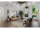 Bright living room with fireplace, large windows, and view to the manicured yard at 1523 E Treasure Cove Dr, Gilbert, AZ 85234