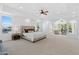 Expansive main bedroom boasts a tray ceiling, neutral carpet and an archway into the living area at 1523 E Treasure Cove Dr, Gilbert, AZ 85234