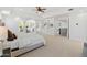 Spacious main bedroom with built-in shelving and staircase, filled with natural light and carpet at 1523 E Treasure Cove Dr, Gilbert, AZ 85234