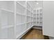 Walk-in pantry features adjustable shelving, recessed lighting, and a wood floor at 1523 E Treasure Cove Dr, Gilbert, AZ 85234