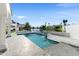 Backyard pool with a waterfall feature, surrounding stone pavers, and canal views at 1523 E Treasure Cove Dr, Gilbert, AZ 85234