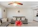 Cozy living room featuring tile floors, a comfortable gray sofa, and natural light at 1635 W Grovers Ave, Phoenix, AZ 85023