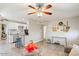 Open-concept living room with tile floors, a ceiling fan, and a view into the modern kitchen at 1635 W Grovers Ave, Phoenix, AZ 85023